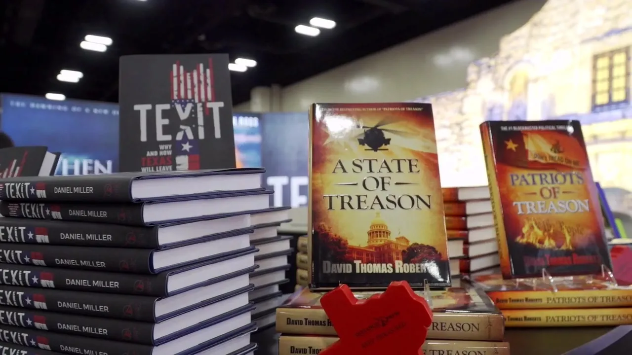 Stacks of TEXIT, A State of Treason, and Patriots of Treason on the Defiance Press table